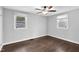 This bedroom offers gray walls, hardwood floors, with two windows for natural light at 3332 Apache Dr, Raleigh, NC 27609