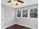 Bedroom with hardwood floors, three windows and a ceiling fan at 3332 Apache Dr, Raleigh, NC 27609