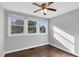Bedroom with hardwood floors, three windows and a ceiling fan at 3332 Apache Dr, Raleigh, NC 27609