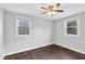 Bedroom with hardwood floors, two windows and a ceiling fan at 3332 Apache Dr, Raleigh, NC 27609