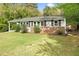 Charming home featuring a brick facade, large windows, and manicured landscaping at 3332 Apache Dr, Raleigh, NC 27609