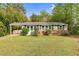 Charming one-story home with a brick base, gray siding, and a covered carport at 3332 Apache Dr, Raleigh, NC 27609