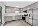 Renovated kitchen with gray cabinets, stainless steel appliances, and wood-look flooring at 3332 Apache Dr, Raleigh, NC 27609