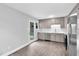 Bright kitchen with gray cabinets, stainless steel appliances, and direct backyard access at 3332 Apache Dr, Raleigh, NC 27609