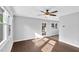 Bright living room features hardwood floors, a ceiling fan and a glass door to let sunlight into the space at 3332 Apache Dr, Raleigh, NC 27609