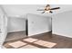 Spacious living room with hardwood floors, a ceiling fan, and neutral paint colors at 3332 Apache Dr, Raleigh, NC 27609