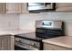 The kitchen showcases a stainless-steel range with glass cooktop and white quartz countertops at 3332 Apache Dr, Raleigh, NC 27609