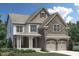 Charming two-story home featuring stone accents, a covered porch, and a two-car garage at 337 Parlier Dr, Cary, NC 27519