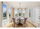 Cozy dining area with large windows, natural light, and a stylish chandelier above a round table at 430 Wyndham Dr, Chapel Hill, NC 27516