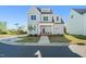 Charming two-story home with light blue siding, complemented by a well-maintained lawn and beautiful landscaping at 430 Wyndham Dr, Chapel Hill, NC 27516