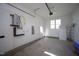 Clean garage featuring a tankless water heater, ample natural light, and epoxy floor at 430 Wyndham Dr, Chapel Hill, NC 27516