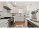 Modern kitchen featuring stainless steel appliances, white cabinets, and an island with seating at 430 Wyndham Dr, Chapel Hill, NC 27516