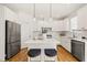 Well-appointed white kitchen with a central island, stainless appliances, and stylish pendant lighting at 430 Wyndham Dr, Chapel Hill, NC 27516