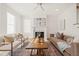 Sunlit living room showcasing a fireplace, comfortable seating, and a rustic wooden coffee table, perfect for entertaining at 430 Wyndham Dr, Chapel Hill, NC 27516