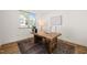 Well-lit office space with a rustic wooden desk, a comfortable chair, and serene decor for a productive work environment at 430 Wyndham Dr, Chapel Hill, NC 27516