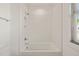 Bright shower and bathtub combo featuring white subway tile, and window for natural light at 430 Wyndham Dr, Chapel Hill, NC 27516