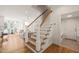 Elegant staircase with wooden steps and white railings, leading to the upper level of the light and airy home at 430 Wyndham Dr, Chapel Hill, NC 27516