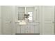 Bright bathroom with double sinks, white cabinetry, and a framed mirror at 456 Barnes Landing Dr # 39, Four Oaks, NC 27524