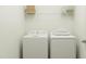 Efficient laundry room with a modern washer and dryer, with overhead shelving for organized storage at 456 Barnes Landing Dr # 39, Four Oaks, NC 27524