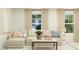 Comfortable living room with neutral decor, large windows, and a sectional sofa for a relaxing atmosphere at 456 Barnes Landing Dr # 39, Four Oaks, NC 27524