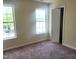 Bedroom with two windows allowing for natural light, complemented by fresh carpeting and neutral walls at 4616 Silverdene St, Raleigh, NC 27616