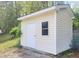 Exterior view of a storage shed nestled among trees, offering extra storage space at 4616 Silverdene St, Raleigh, NC 27616