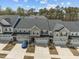 An aerial view highlights the charming townhomes with attached garages and landscaped yards at 486 Autumn Rain St, Cary, NC 27519