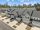 An aerial view highlights the charming townhomes with attached garages and landscaped yards at 486 Autumn Rain St, Cary, NC 27519