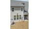 View of the home's backyard featuring a small patio area with chair, and exterior elements such as siding and windows at 486 Autumn Rain St, Cary, NC 27519