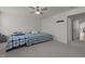 Cozy bedroom with neutral tones, gray carpet, ceiling fan, and two beds at 486 Autumn Rain St, Cary, NC 27519