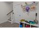 Charming entryway area with stairs, white door, and decorative shelving space for storage and personal items at 486 Autumn Rain St, Cary, NC 27519