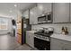 Well-equipped kitchen features stainless steel appliances, modern cabinetry, and a unique colorful refrigerator at 486 Autumn Rain St, Cary, NC 27519