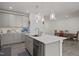 Stylish kitchen island boasts modern pendant lighting, stainless steel dishwasher, and ample counter space at 486 Autumn Rain St, Cary, NC 27519