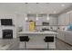 Modern kitchen with a spacious island, stylish bar seating, and a beautiful view of the living area and fireplace at 486 Autumn Rain St, Cary, NC 27519