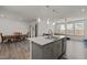 Bright and open kitchen featuring an island, modern appliances, and seamless connection to the dining and living areas at 486 Autumn Rain St, Cary, NC 27519