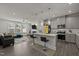 Contemporary kitchen featuring an island, pendant lighting, and stainless steel appliances, seamlessly flowing into the living area at 486 Autumn Rain St, Cary, NC 27519