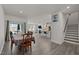 Open-concept living area with hardwood floors, dining space, and kitchen with bar seating at 486 Autumn Rain St, Cary, NC 27519