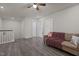 Cozy living room featuring hardwood floors, ceiling fan, and comfortable seating area at 486 Autumn Rain St, Cary, NC 27519