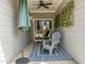 Covered patio with outdoor chairs and decor at 486 Autumn Rain St, Cary, NC 27519