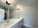 Bathroom featuring double sinks, white quartz counters and a large mirror at 486 Traditions Grande Blvd # 28, Wake Forest, NC 27587