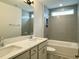 Modern bathroom featuring double sinks, quartz counters and a bathtub with tiled shower at 486 Traditions Grande Blvd # 28, Wake Forest, NC 27587