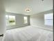 Spacious bedroom with plush carpet and lots of light from three large windows at 486 Traditions Grande Blvd # 28, Wake Forest, NC 27587