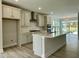 Well-appointed kitchen with white cabinets, stainless steel appliances, and a large island, open to the dining area at 486 Traditions Grande Blvd # 28, Wake Forest, NC 27587