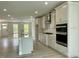Modern kitchen featuring white cabinets, a large island with seating, stainless steel appliances, and plenty of counter space at 486 Traditions Grande Blvd # 28, Wake Forest, NC 27587