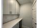 Convenient laundry room with white cabinets, ample counter space, and a clean, modern design at 486 Traditions Grande Blvd # 28, Wake Forest, NC 27587