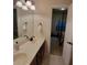 Bathroom with double vanity, mirror, and view into the bedroom at 502 Willowmere Ct, Cary, NC 27513