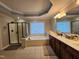 Bathroom features double vanity, shower, large soaking tub, and natural light at 502 Willowmere Ct, Cary, NC 27513