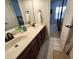 Bathroom featuring a double sink vanity with dark wood cabinets and tile floors at 502 Willowmere Ct, Cary, NC 27513