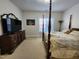 Bright bedroom with four poster bed, dresser, and large TV for entertainment at 502 Willowmere Ct, Cary, NC 27513