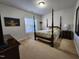 Cozy bedroom with four poster bed, side tables, and a picturesque window view at 502 Willowmere Ct, Cary, NC 27513